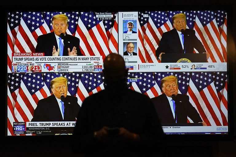A live broadcast of Donald Trump speaking from the White House is shown on screens at an election-night party in Las Vegas. (John Locher/AP)