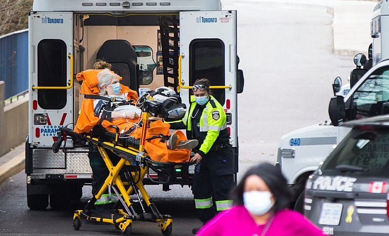 A patient is wheeled out of an ambulance to a hospital in Toronto, Canada, on Nov. 16, 2020. (Photo by Zou Zheng/Xinhua) (Xinhua/Zou Zheng via Getty Images)