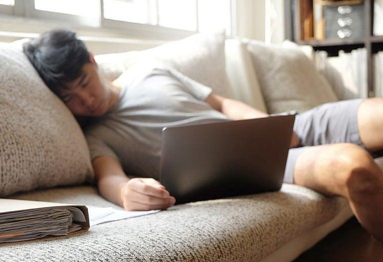A man sleeping while working from home. (iStock)