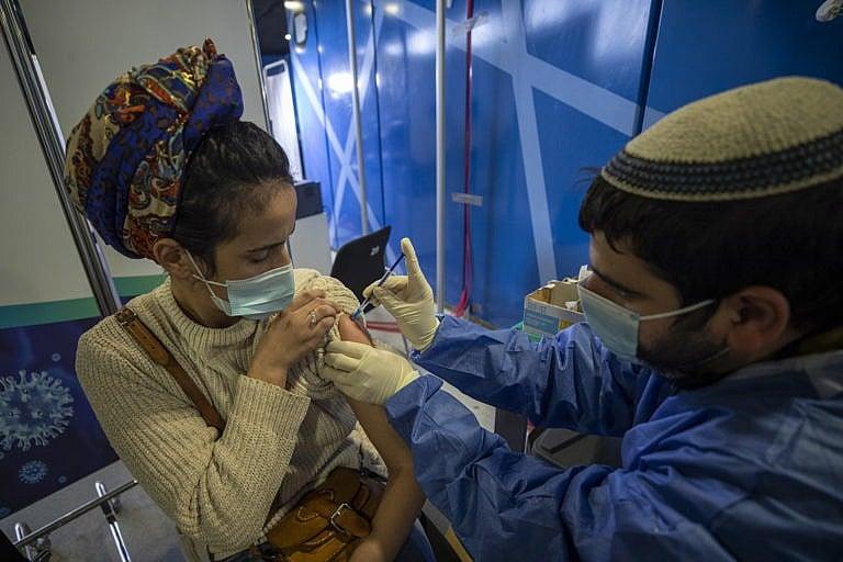 A woman is vaccinated against COVID-19 on Tuesday in the Medical Center in Jerusalem. Israel had by this point vaccinated over four and a-half million of its nine million citizens; three million had been given a second dose. (Atef Safadi/EPA via CP)