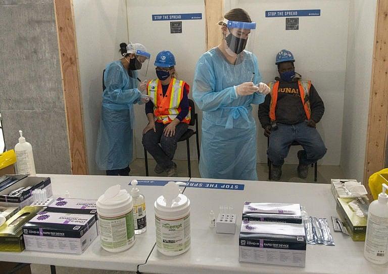 Nurses administer rapid COVID-19 tests at a construction site n Toronto on Thursday, February 18, 2021. THE CANADIAN PRESS/Frank Gunn
