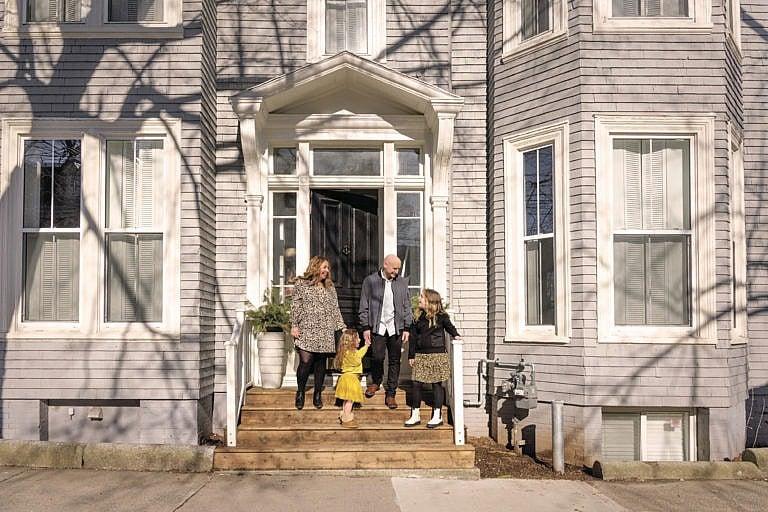 Melissa Mahoney and her family stand in front of their home in Halifax, Nova Scotia. (Photograph by Carolina Andrade)