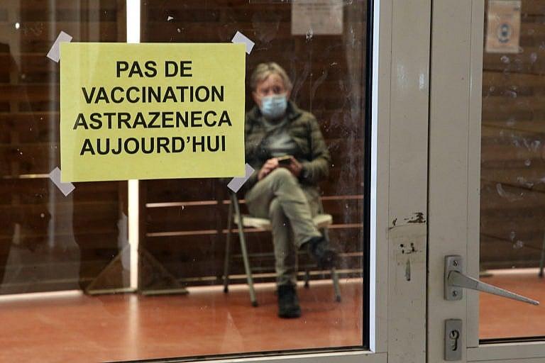A man waits in a vaccination centre where a sign reads "No AstraZeneca vaccinations today" in Saint-Jean-de-Luz, southwestern France, Tuesday, March 16, 2021. (AP Photo/Bob Edme)