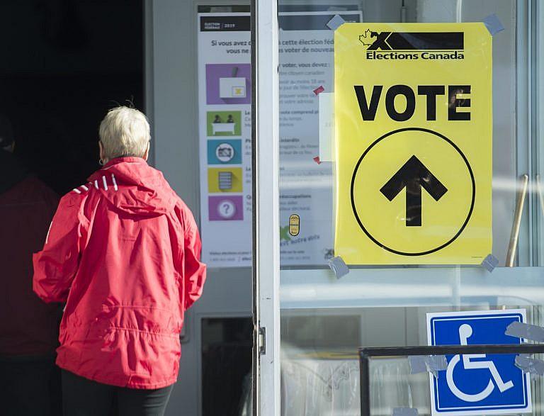 People arrive to cast their ballots at a polling station on federal election day in Shawinigan, Que., on Oct. 21, 2019 (CP/Graham Hughes)
