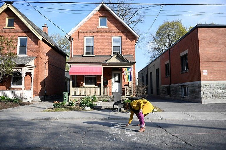 Kaplan-Myrth uses chalk to designate a waiting area outside her medical clinic in Ottawa (Photograph by Justin Tang)