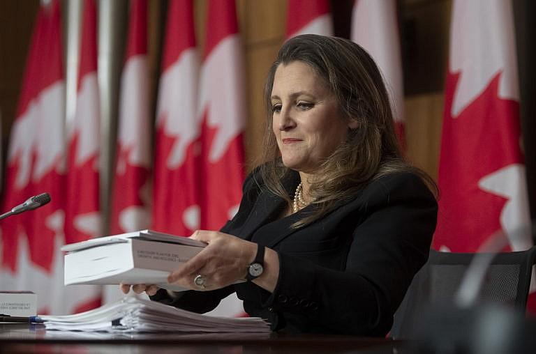 Minister of Finance Chrystia Freeland holds a copy of the budget at a news conference in Ottawa on Monday. (Adrian Wyld/CP)