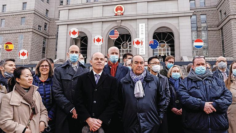 Jim Nickel, charge d'affaires of the Canadian Embassy in Beijing, and William "Bill" Klein, acting deputy chief of mission of the U.S. Embassy in Beijing, stand with foreign diplomats outside Beijing No. 2 Intermediate People's Court where Michael Kovrig was tried on March 22, 2021.(Carlos Garcia Rawlins/Reuters)