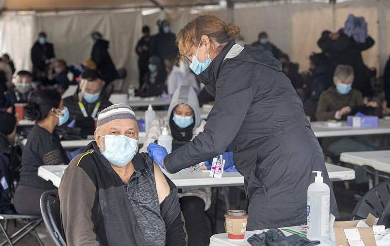 A nurse administers a COVID-19 vaccine at a pop-up clinic at the Masjid Darus Salaam in the Thorncliffe Park neighbourhood in Toronto on Sunday, April 11, 2021. THE CANADIAN PRESS/Frank Gunn
