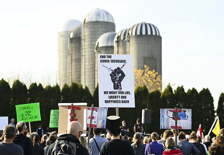 People gather to protest mandatory masks at a anti-mask demonstration during the COVID-19 pandemic in Aylmer, Ont., on Saturday, November 7, 2020. The town declared a state of emergency regarding the issue. (Nathan Denette/CP)