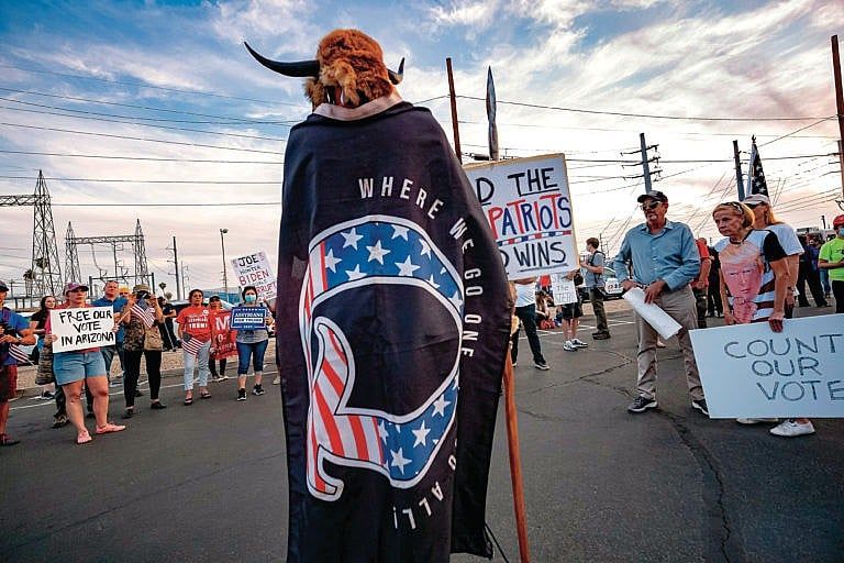 QAnon followers have lost no faith in the movement, despite its many prophetic failures (Olivier Touron/AFP/Getty Images)