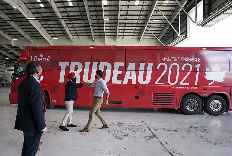 Trudeau greets MP candidates as he makes a campaign stop in an airplane hanger in Mississauga, Ont., on Sept. 3, 2021 (Nathan Denette/CP)