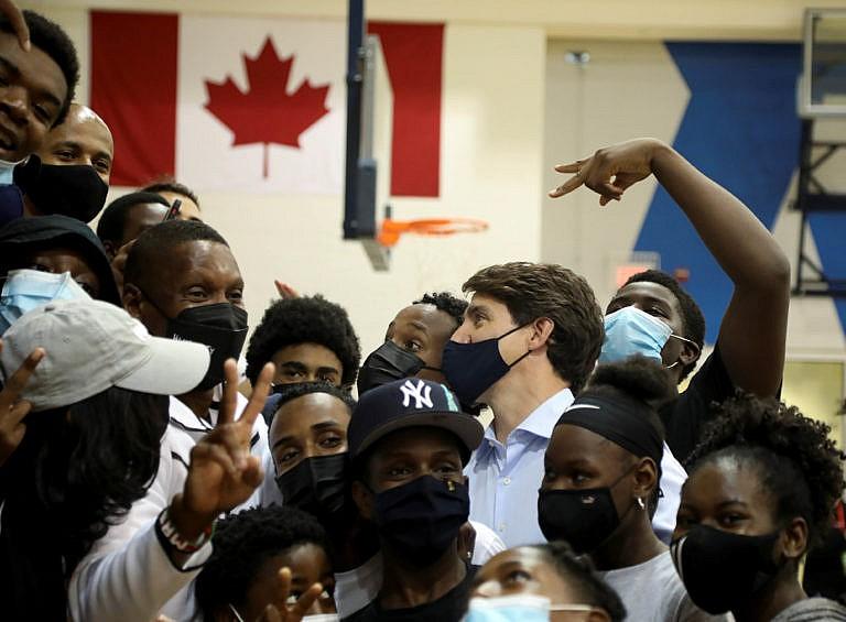 Canada's Liberal Prime Minister Justin Trudeau talks to members of the Toronto Raptors youth programs, alongside Masai Ujiri, the President of the team, at the Mattamy Athletic Centre during Trudeau's election campaign tour in Toronto, Ontario, Canada September 1, 2021. (Carlos Osorio/Reuters)
