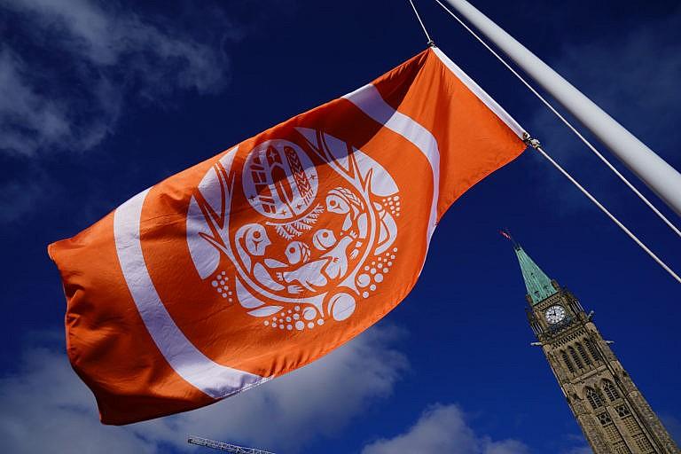 An orange flag flies during the National Day for Truth and Reconciliation in Ottawa on Sept. 30, 2021. (Sean Kilpatrick/Canadian Press)