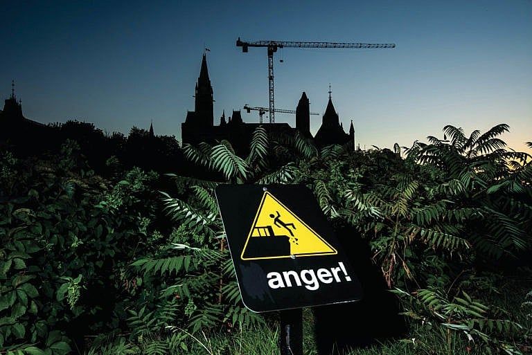 The letter "d" on a "danger" sign at Major's Hill park advising people to stay away from the cliff edge is painted over, leaving the word "anger", seen in front of Parliament Hill in Ottawa, on Thursday, Sept. 16, 2021. (Photograph by Justin Tang)