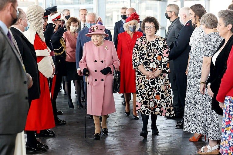 Queen Elizabeth II walks with Elin Jones, Llywydd of the Senedd, as Prince Charles, Prince of Wales and Camilla, Duchess of Cornwall walk behind at the opening ceremony of the sixth session of the Senedd at The Senedd on October 14, 2021 in Cardiff, Wales. (Chris Jackson/Getty Images)