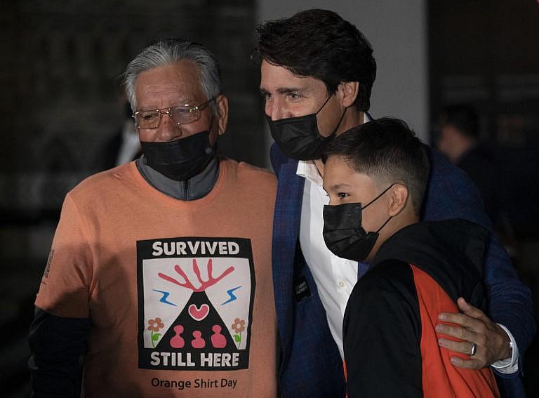 A survivor and family with Justin Trudeau on Parliament Hill on the eve of the first National Day of Truth and Reconciliation, September 29, 2021. (Adrian Wyld/Canadian Press)