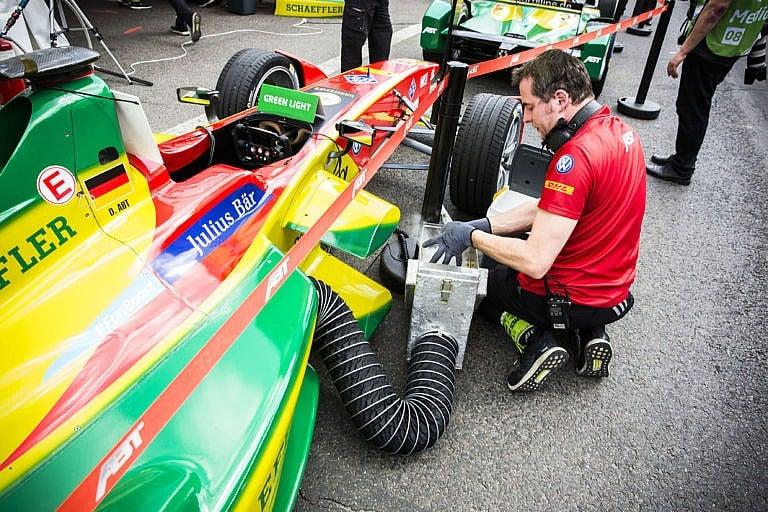 At a Formula E race in Berlin, Germany, a technician loads dry ice into an electric car to cool its batteries during a pit stop (Felix Clay/eyevine/Redux)