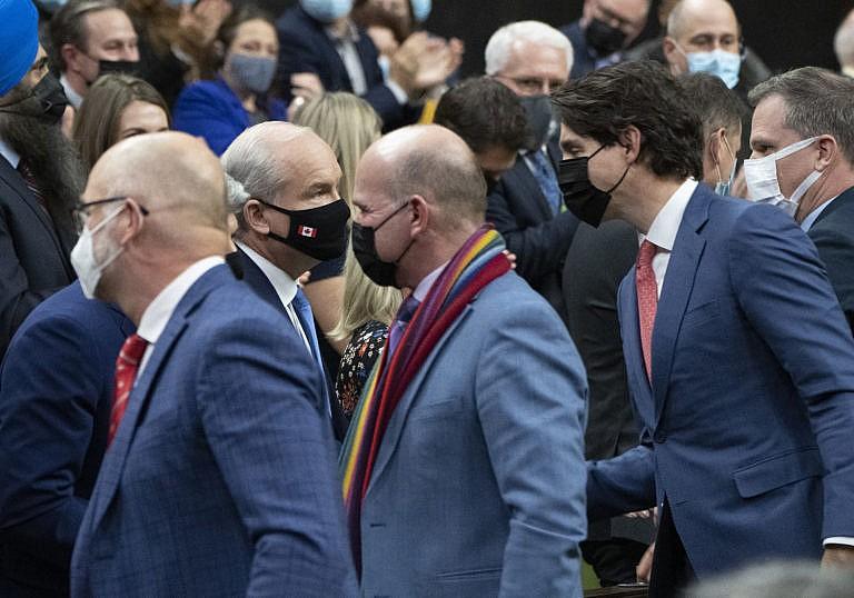 Justin Trudeau, David Lametti, Randy Boissonnault and Mark Holland shake hands with Erin O'Toole and MPs after the unanimous adoption of legislation banning conversion therapy, December 1, 2021 in Ottawa. (Adrian Wyld/Canadian Press)