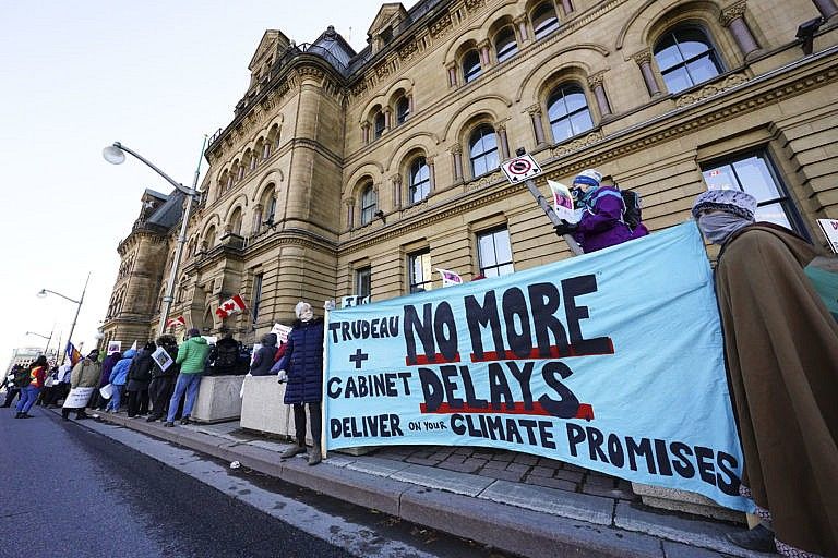 Climate action protestors gather in front of the PMO office in Ottawa, Nov. 22, 2021. (Sean Kilpatrick/The Canadian Press)