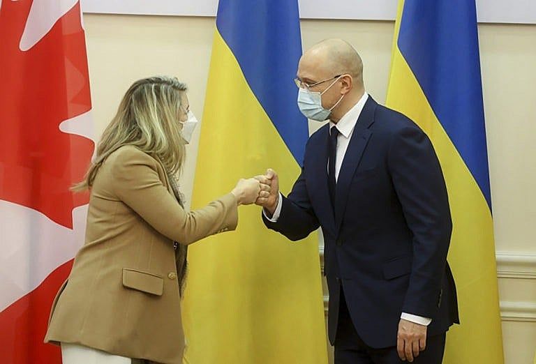 Ukraine's Prime Minister Denis Shmygal and Minister of Foreign Affairs Melanie Joly greet each other during their meeting in Kyiv, Ukraine on Jan. 17, 2022. (Ukrainian Prime Minister Press Office via AP)