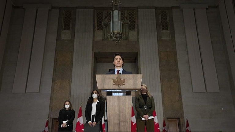 Deputy Prime Minister and Finance Minister Chrystia Freeland, Defence Minister Anita Anand and Foreign Affairs Minister Melanie Joly look on as Canadian Prime Minister Justin Trudeau speaks during a news conference, Feb. 24, 2022 in Ottawa. (Adrian Wyld/The Canadian Press)