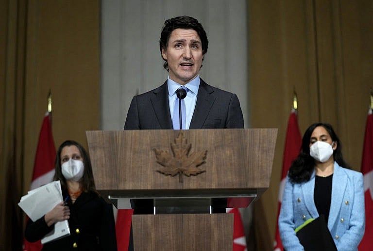 Prime Minister Justin Trudeau is joined by Deputy Prime Minister and Minister of Finance Chrystia Freeland, left, Minister of National Defence Anita Anand, as he speaks during a media availability on the situation in Ukraine, in Ottawa, Feb. 22, 2022. (Justin Tang/The Canadian Press)