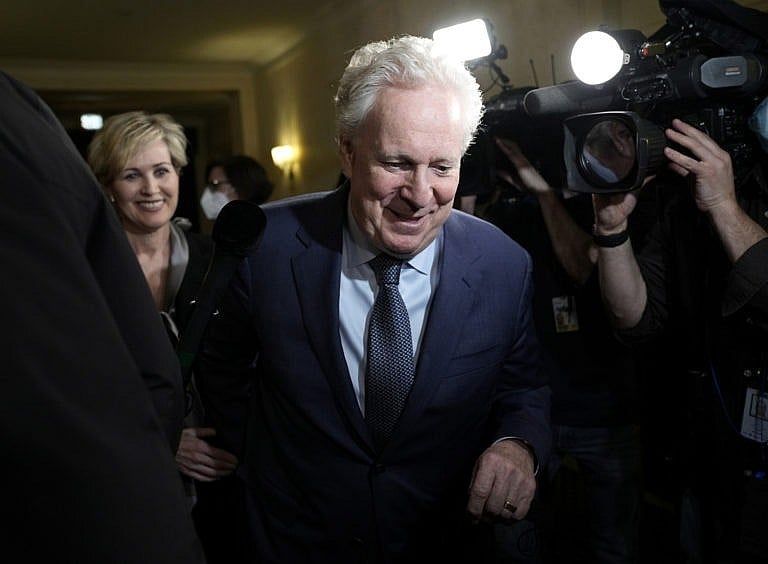 Charest arrives with his wife Michele Dionne for an event with potential caucus supporters in Ottawa, on March 2, 2022 (Justin Tang/CP)