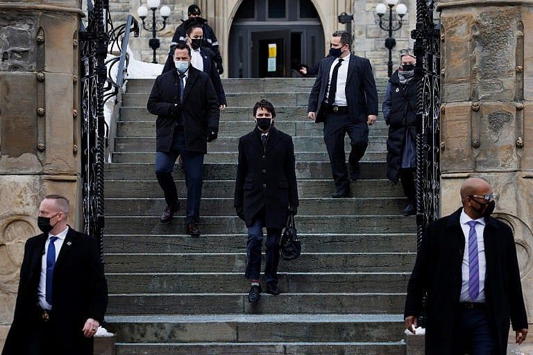 Justin Trudeau walks to a news conference after police ended three weeks of occupation of the capital by protesters seeking to end coronavirus disease (COVID-19) vaccine mandates in Ottawa, Feb. 21, 2022. (Blair Gable/Reuters)