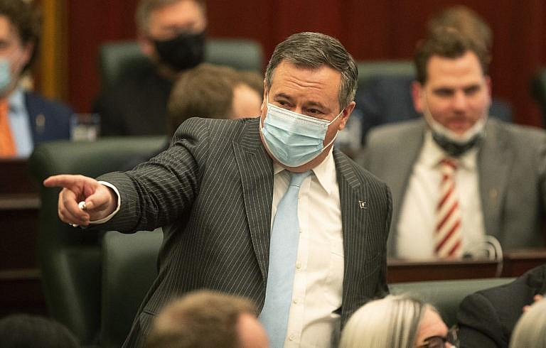 Kenney points to people in the chamber, Edmonton, Feb. 22, 2022. (Jason Franson/The Canadian Press)