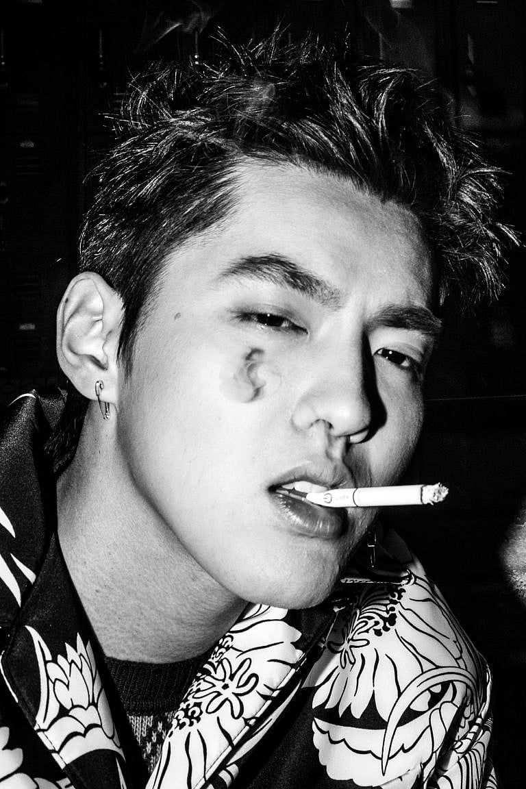 A close up of a young man smoking
