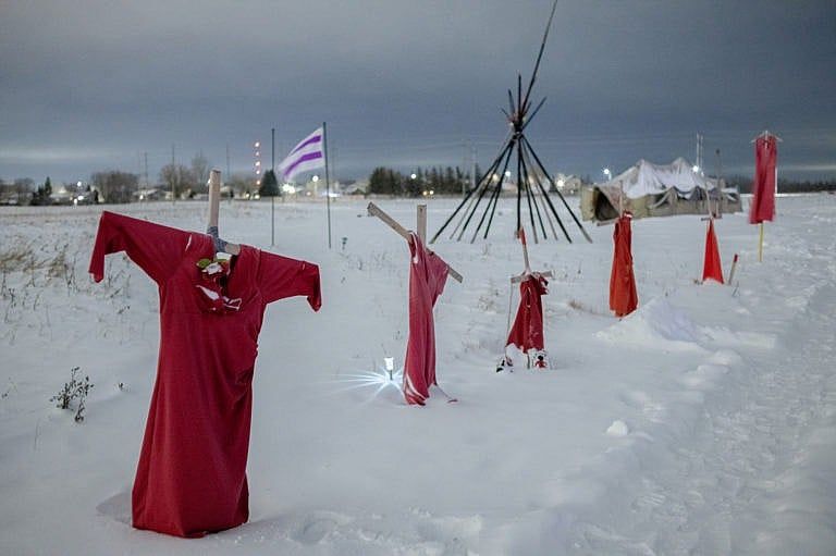 A picture of red dresses hanging in the snow