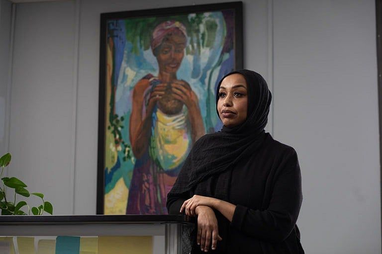A photo of a Black woman in a hijab looking to the left